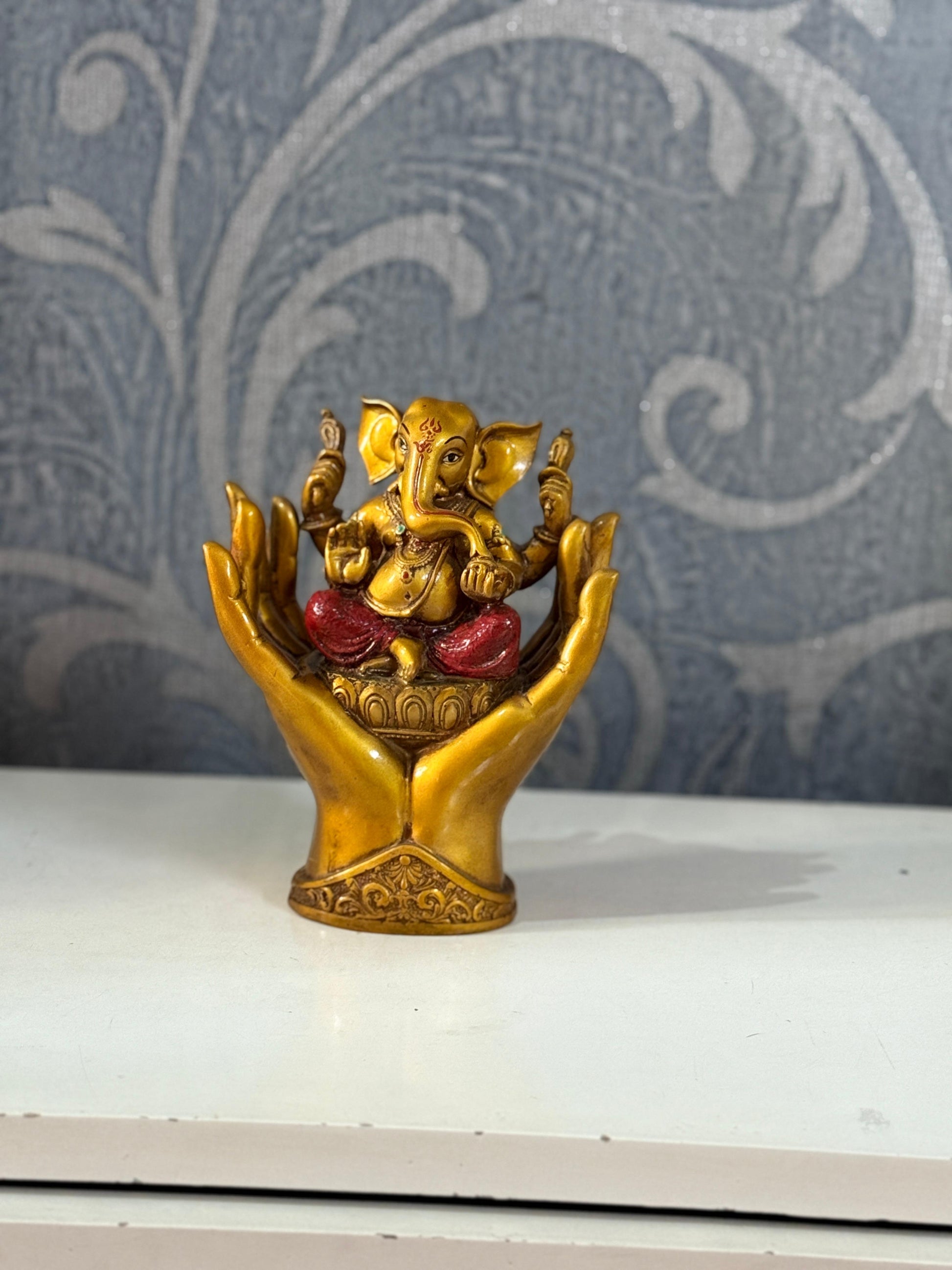 Divine Lord Ganesha Idol in Protective Hands – Symbol of Blessings & Prosperity