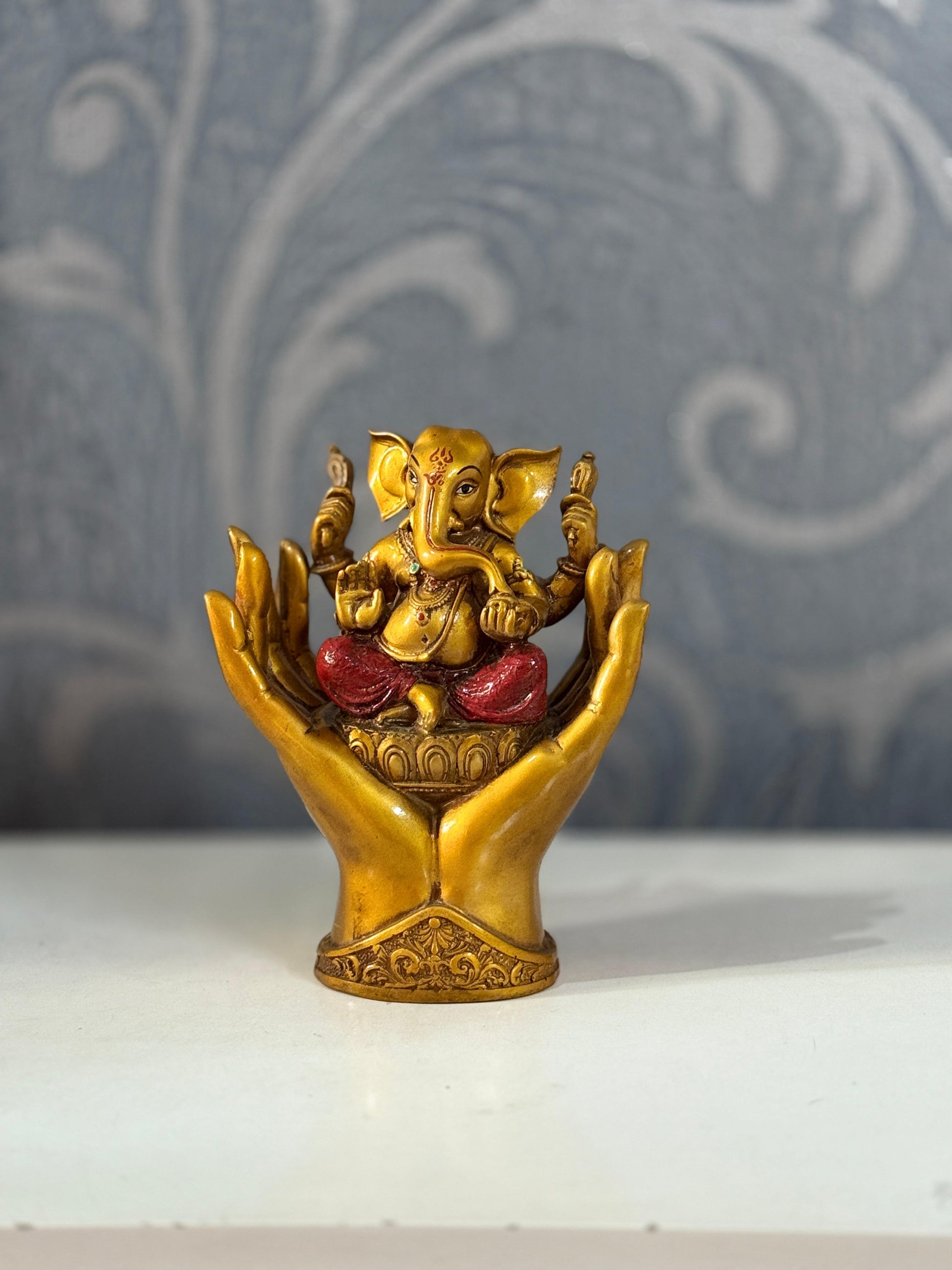 Divine Lord Ganesha Idol in Protective Hands – Symbol of Blessings & Prosperity